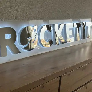 Mirrored flat-cut metal letter sign detail